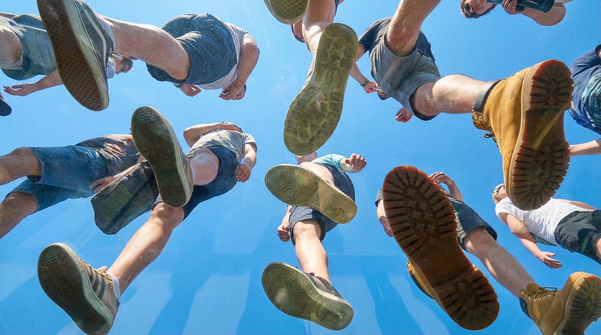 Underfoot Plexiglass Sky Background with Walking People