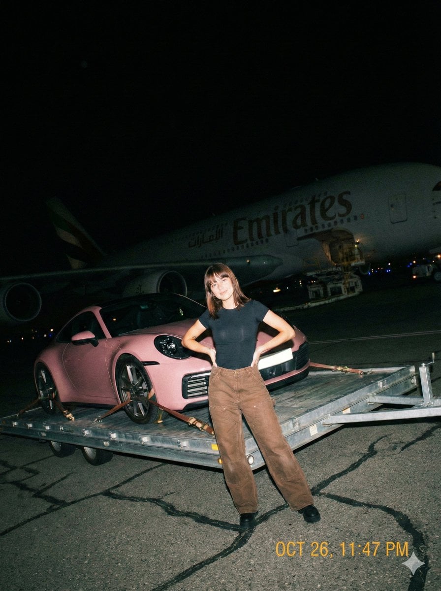 Woman Beside Pink Porsche on Airport Tarmac